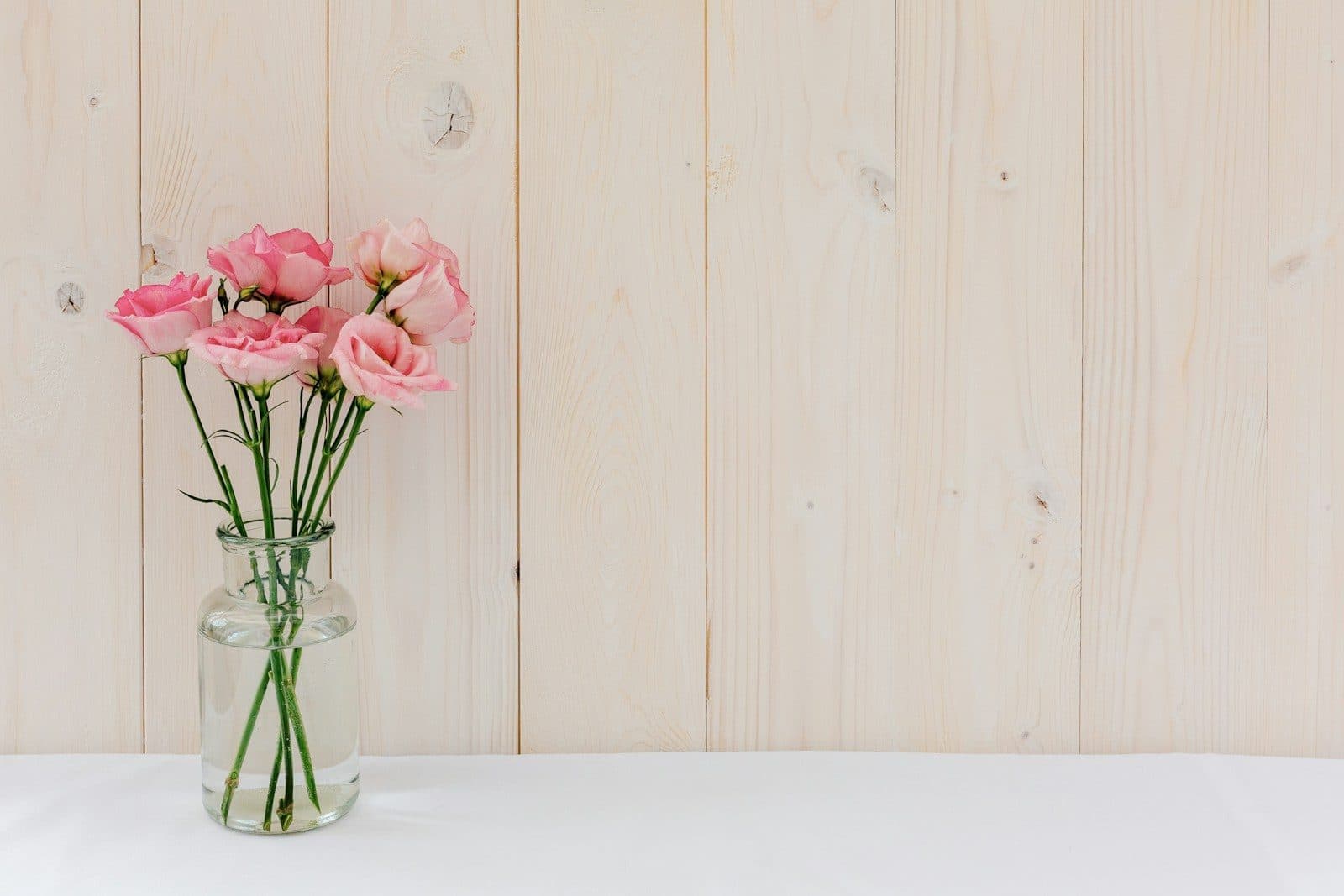 Soft pink roses in a glass vase